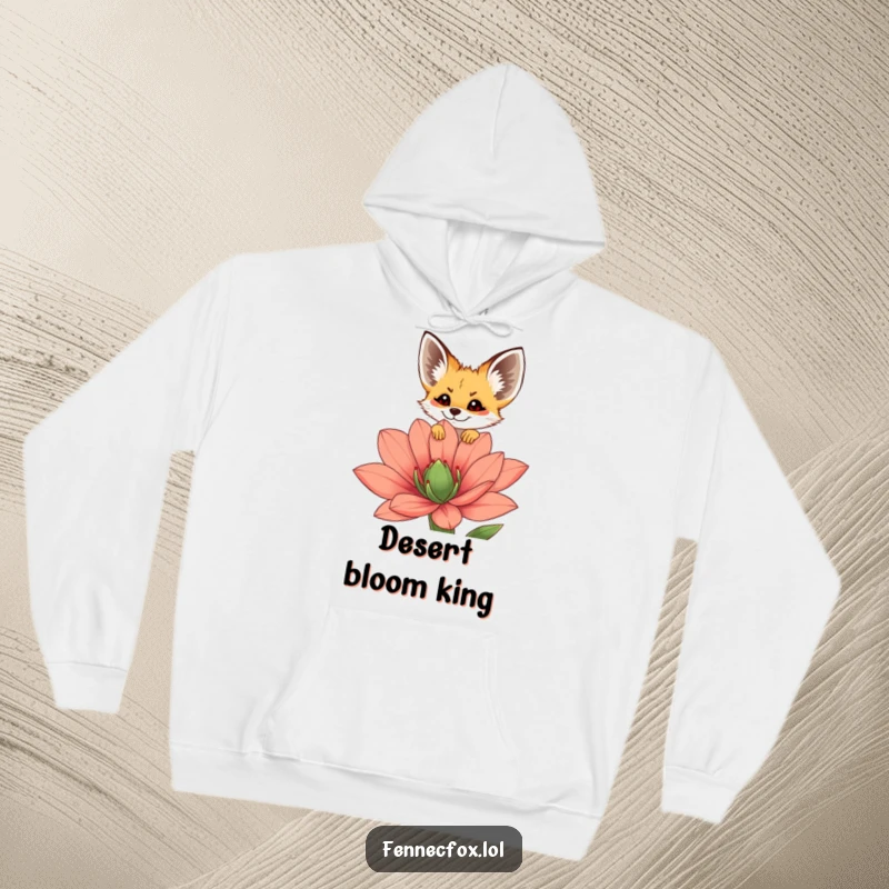 Funny fennec fox hoodie with a cheerful fennec peeking over a large, colorful desert flower, emphasizing coziness and cuteness.