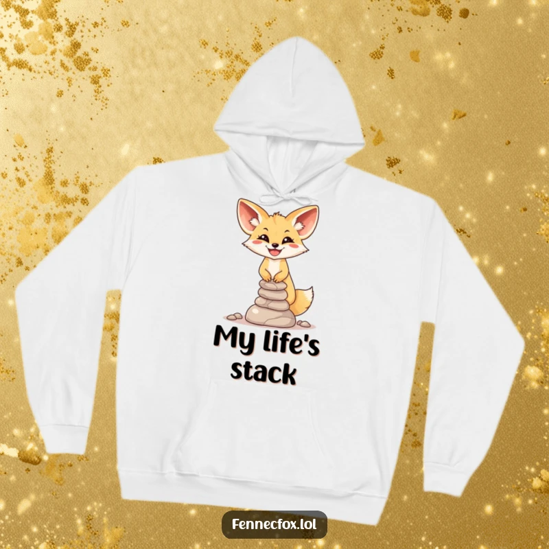 Funny Fennec Fox Hoodie: A big-smiling fox is shown precariously balancing a small, unstable tower of desert stones.