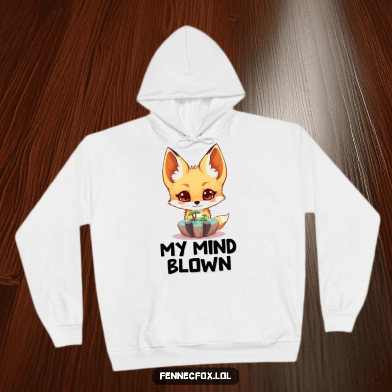 Funny fennec fox hoodie showing a surprised character observing a tiny floating oasis, perfect for cozy and magical wear.