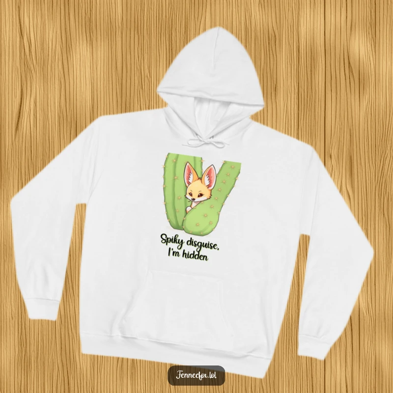 Funny fennec fox hiding behind a large spiky cactus, desert-themed, cozy humorous hoodie.