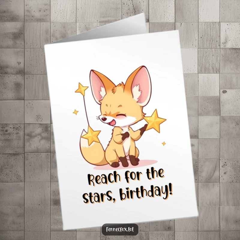 Funny Free Printable Birthday Card featuring a giggling fennec fox batting at a sparkling desert star, wishing celestial birthday joy.