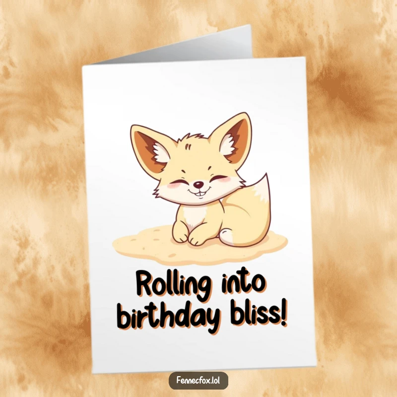 Funny Free Printable Birthday Card: A fennec fox with a wide mischievous grin rolls happily in soft desert sand.