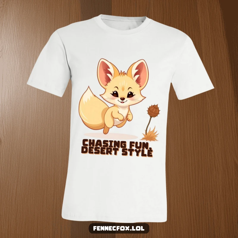 Funny Fennec Fox T-Shirt: A cute fennec fox with a slight smile enthusiastically pursues a lively tumbleweed across a sandy landscape.