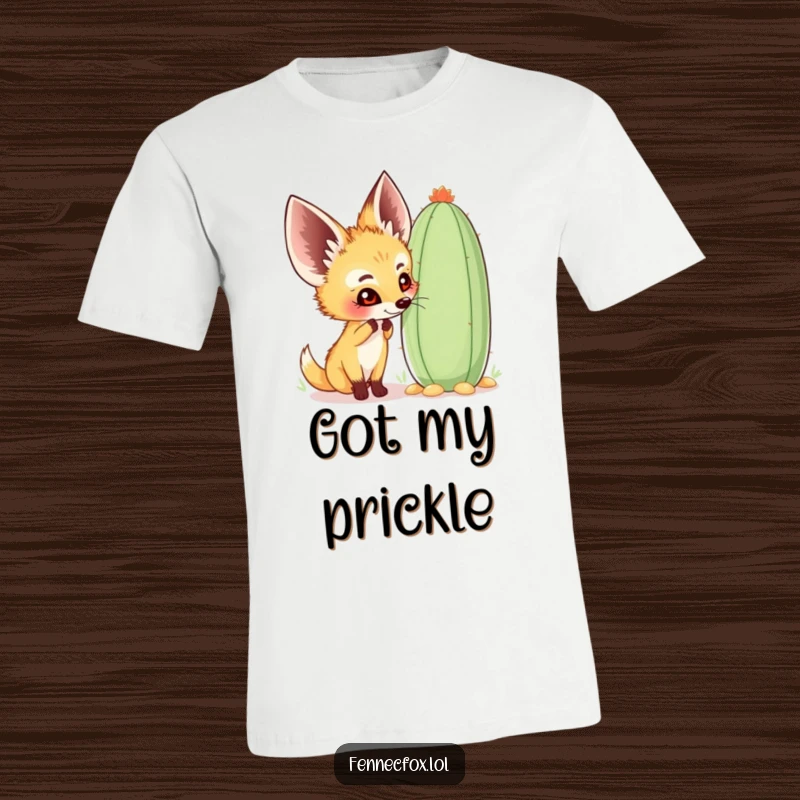 Funny fennec fox t-shirt depicting a happy character curiously sniffing a large, whimsical cactus, perfect for desert enthusiasts.